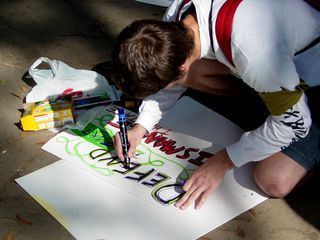 A number of people took a moment to make signs in the park.