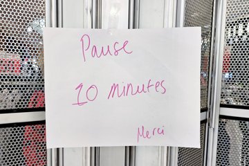 "Back in 10 minutes, thanks," sign on the gate of the Ecko Unltd. store.