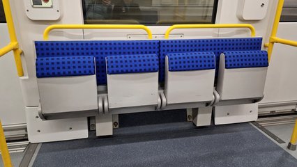 Cooperative seating, which we would call "priority seating" in the States, where able-bodied passengers should be prepared to give up their seat should someone board who needs it more than they do.  The seats also fold up, as shown here, to accommodate wheelchair users.