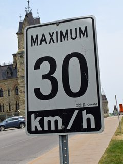 Canadian-style speed limit sign on Parliament Hill.  30 km/h is roughly 19 mph.