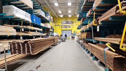 Lumber aisle at Réno-Dépôt, identical to what one would find at a Lowe's, but with Réno-Dépôt's teal and yellow color palette.