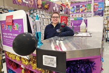 Elyse smiles for a photo at the balloon counter.