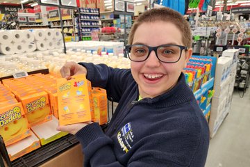 Elyse holds up a Scrub Daddy sponge, showing off the Canadian packaging.