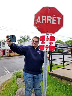 Elyse poses for a photo and gets a selfie with the Quebec-style four-way stop at Boulevard Montclair and Rue Berri.