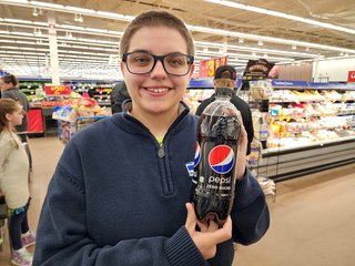 Elyse holds up a one-liter bottle of Pepsi Zero Sugar with the bilingual labeling.