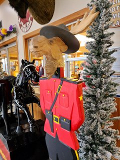 Moose in a mountie uniform at the store's entrance.