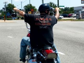 The motorcycle guy and his shirt: "Gas, grass, or ass: no one rides for free!"