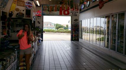 The girl working in the store poses for a photo.