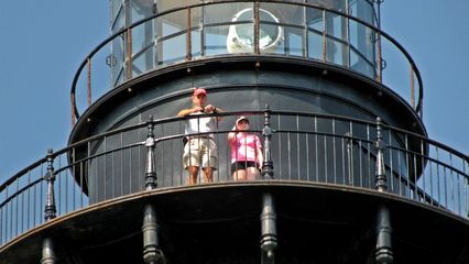 Two people up on the balcony, viewed from the ground.
