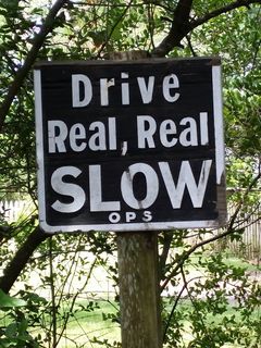 "Drive Real, Real SLOW" as seen on a sign on the narrow dirt road leading to Village Craftsmen.