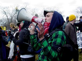 A person works the bullhorn to get the attention of the SDS crowd, so we could determine what we were going to do.