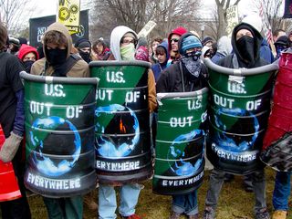And just like on J27, the shields led the black bloc. We not only had the green "US OUT OF EVERYWHERE" shields from before, but we also had a new set of shields made out of construction barrels painted red and black in the style of the anarcho-syndicalist flag.