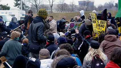 Meanwhile, we were basically at an impasse with the police. Neither side was about to back down. The seated black bloc stood their ground, and the gas-masked cops held theirs.