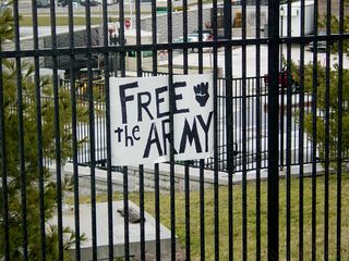One person stuck a sign saying "Free the Army" in a nearby fence.