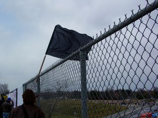 A black flag flew from another fence.