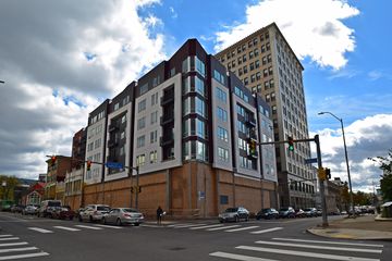 New apartment building, constructed earlier this year according to Street View, across South Highland Avenue from the church, replacing an older, two-story building. The first floor is completely boarded up, presumably because a retail tenant has not yet been located to build out the space.