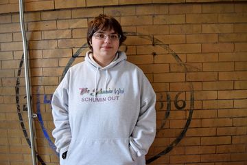 Elyse poses for a photo in front of some of the gym's vintage paintwork. And yes, that is an older Schumin Web hoodie that Elyse is wearing.