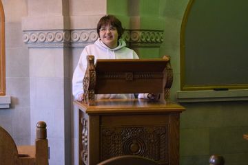 Elyse stands at the Armenian Room lectern.
