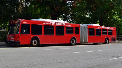 A Port Authority bus, spotted here outside the Cathedral of Learning. Pittsburgh's buses are many different colors, with similar text on them. The 40-foot buses are Gillig Low Floor, while the artics are New Flyer D60LFR.