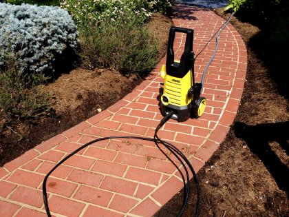 The power washer on the front walk during a cleaning operation