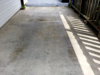 The carport, before cleaning. My father washes cars in this area, and so this area sees a good bit of road dirt going onto it from that.
