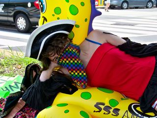 A member of the Epic Fail Brigade lays on an inflatable sea creature in the median of Connecticut Avenue.