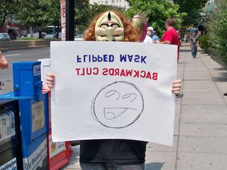 With a flipped mask, this Anon indicates that Scientology is also backwards.