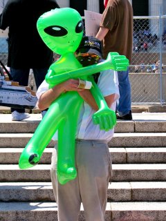 An Anon hugs an inflatable Xenu.