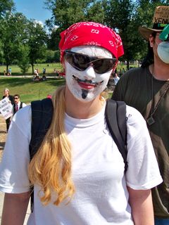 Rather than wear a Guy Fawkes mask in this heat, one female Anon painted the features of the mask directly onto her face. Creative...