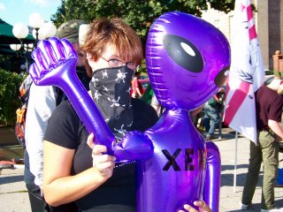 Later, at our full raid at the Org, a masked woman waves with an inflatable Xenu.