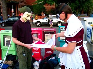 MisterTastee and Vendetta fold the Anonymous DC flag.