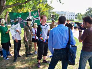 Later, Wutman gave an interview to some filmmakers that encountered us in Lafayette Square, with one of our Anon flags in the background, and of course, Schumin Web on his chest.