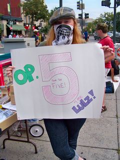 Another Anon holds a Project Five sign.