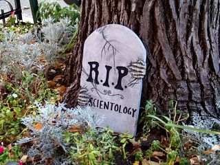 "R.I.P. Scientology" on a fake tombstone placed in a small garden directly in front of the entrance to the Founding Org.