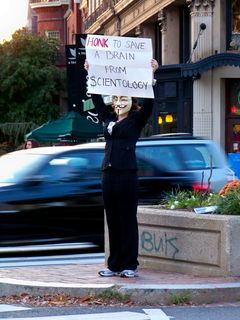 MaidofWin holds a sign for the cars that says, "HONK to save a brain from Scientology". The wording was my idea.