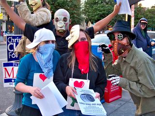 A group stops to pose for a photo in the midst of handing out flyers.