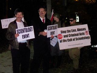 Enturbulating "Borat" (the guy at left, so nicknamed because he bears a strong resemblance to Borat) and another gentleman holding signs to direct other Scilons to the event.