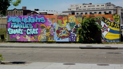 On May 29, while the World War II Memorial was being dedicated, I went railfanning up the Green Line.  This wall around a vacant lot was painted up to show some "neighborhood pride" outside the Columbia Heights Metro station.