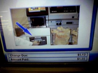 On July 5, I finally got a shot of the mistake on the self checkouts at the Waynesboro Wal-Mart.  When it showed where the change came out, the bags shown weren't Wal-Mart bags.  Instead, they were Home Depot bags, with the message "Thank you for shopping The Home Depot" clearly readable on the bags.  This was later edited out.