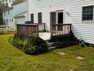 Before the work started, we had ivy growing around the bottom of the deck, the area was very much open air, and the deck had stepping stones leading to it.