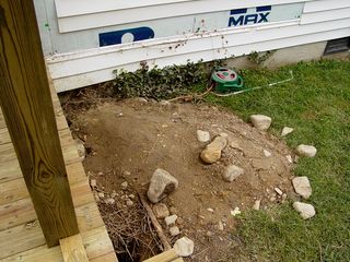 The excavation of the holes produced a considerable amount of dirt in piles around the yard. They also pulled out quite a bit of rocks!
