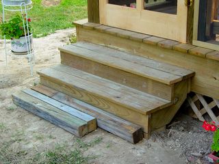 These are the new doggy-friendly steps, though the bottom step was still a bit of a jump for Greta. One more step was added below the lowest step, where the loose wood is here. This way, Greta can use the stairs herself. If nothing else, our house is 100% dachshund-accessible.