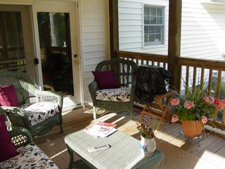 Wicker furniture and a TV set now makes the porch into a comfortable room.