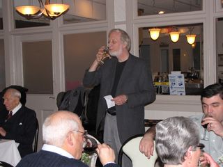 Dan Lysy (Chris's father) has a sip of wine after giving the toast.