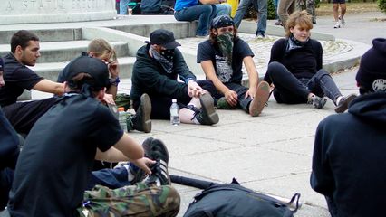Black bloc participants take a moment to stretch before the march.