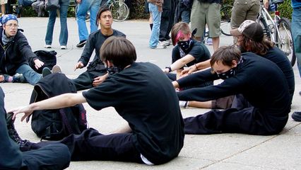 Black bloc participants take a moment to stretch before the march.