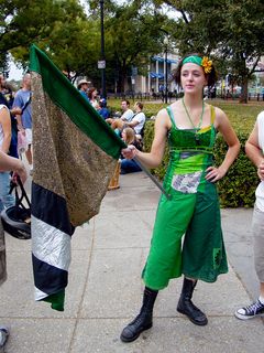 Becca from the Rude Mechanical Orchestra poses with her flag.