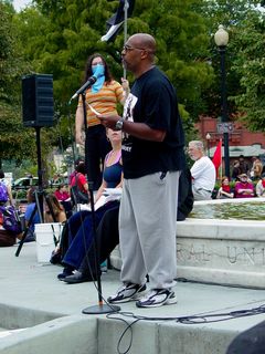 Another gentleman gives a speech from the fountain.