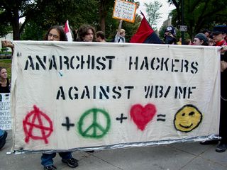 Another group carries a banner similar to that of the Hacktivist group.