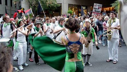 The Rude Mechanical Orchestra takes up their instruments while Becca flies her flag.